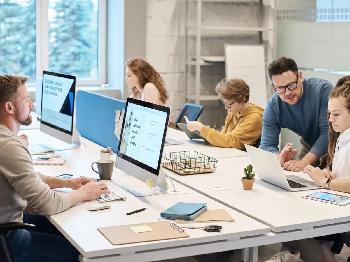 A team working at their computers in a bright, modern office.